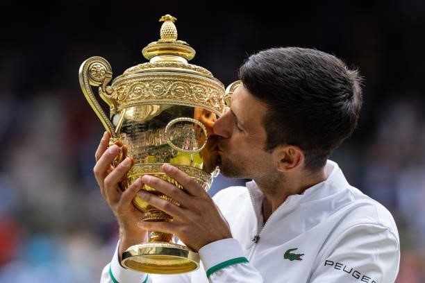 Novak Djokovic of Serbia celebrates with the trophy after winning his men's Singles Final match against Matteo Berrettini of Italy on Day Thirteen of...