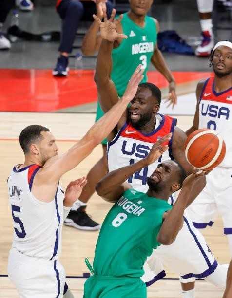 Ekpe Udoh of Nigeria is fouled by Draymond Green of the United States as Zach LaVine of the United States defends during an exhibition game at...