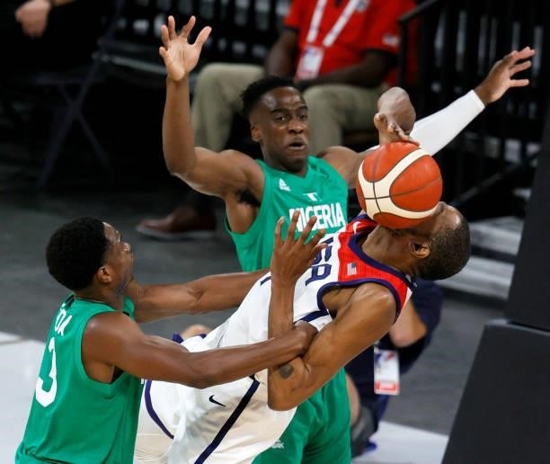 Caleb Agada of Nigeria fouls Kevin Durant of the United States as Miye Oni of Nigeria defends during an exhibition game at Michelob ULTRA Arena ahead...