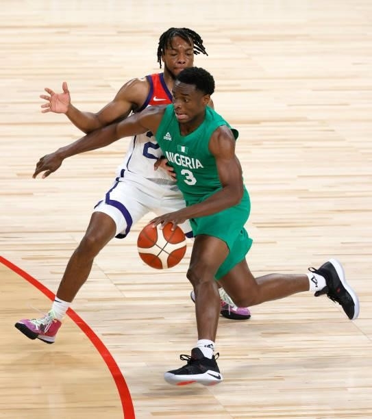 Caleb Agada of Nigeria drives against Darius Garland of the United States during an exhibition game at Michelob ULTRA Arena ahead of the Tokyo...