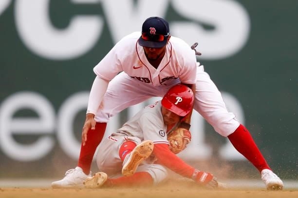 Xander Bogaerts of the Boston Red Sox tags out Ronald Torreyes of the Philadelphia Phillies at second base during the ninth inning at Fenway Park on...