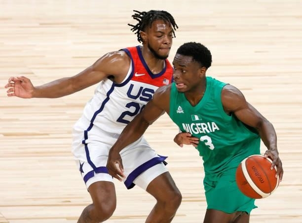 Caleb Agada of Nigeria drives against Darius Garland of the United States during an exhibition game at Michelob ULTRA Arena ahead of the Tokyo...