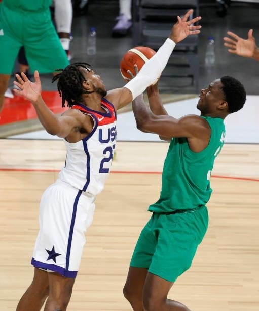 Caleb Agada of Nigeria shoots against Darius Garland of the United States during an exhibition game at Michelob ULTRA Arena ahead of the Tokyo...