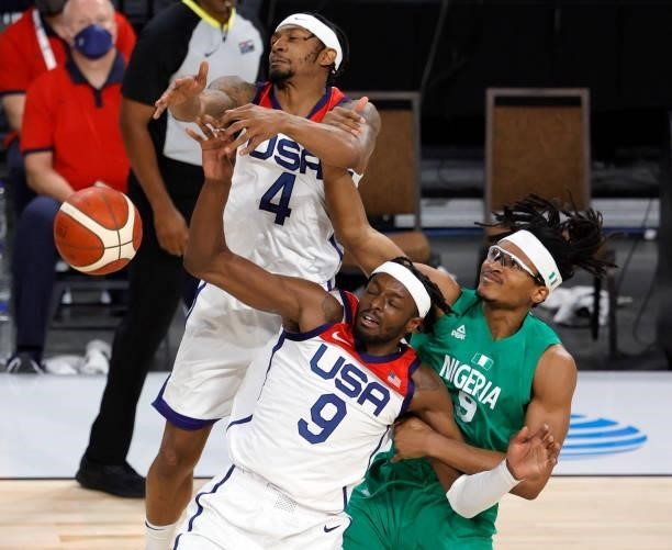 Jerami Grant and Bradley Beal of the United States and Chima Moneke of Nigeria fight for a rebound during an exhibition game at Michelob ULTRA Arena...