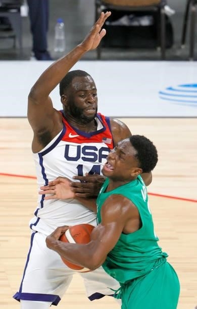 Caleb Agada of Nigeria drives against Draymond Green of the United States during an exhibition game at Michelob ULTRA Arena ahead of the Tokyo...