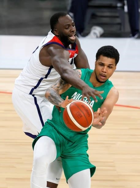 Michael Gbinije of Nigeria passes under pressure from Draymond Green of the United States during an exhibition game at Michelob ULTRA Arena ahead of...