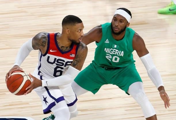 Damian Lillard of the United States is guarded by Josh Okogie of Nigeria during an exhibition game at Michelob ULTRA Arena ahead of the Tokyo Olympic...