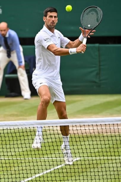 Novak Djokovic of Serbia hits a backhand against Mateo Berrettini of Italy in the final of the gentlemen's singles during Day Thirteen of The...