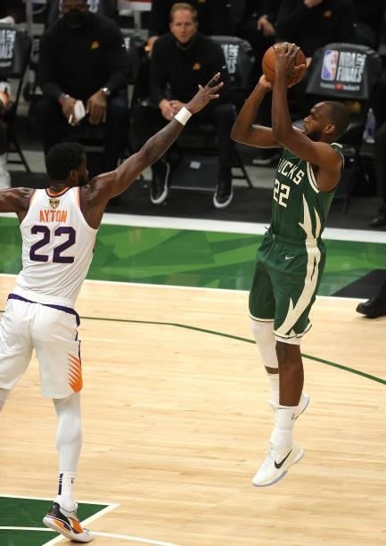 Khris Middleton of the Milwaukee Bucks takes a jump shot over Deandre Ayton of the Phoenix Suns during the first half in Game Three of the NBA Finals...