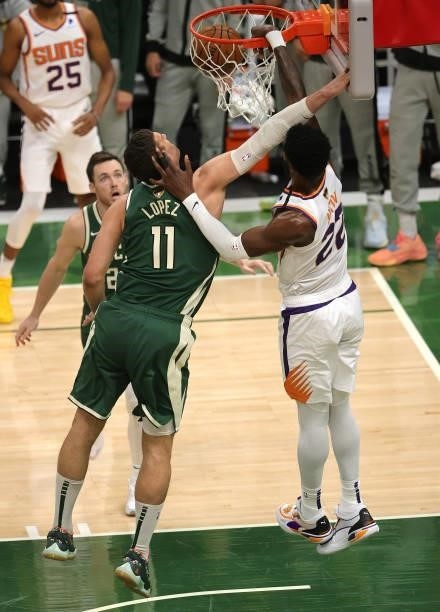 Deandre Ayton of the Phoenix Suns dunks over Brook Lopez of the Milwaukee Bucks during the first half in Game Three of the NBA Finals at Fiserv Forum...
