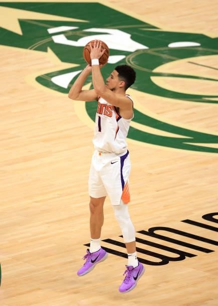 Devin Booker of the Phoenix Suns takes a jump shot during the first half in Game Three of the NBA Finals against the Milwaukee Bucks at Fiserv Forum...