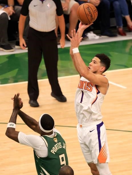 Devin Booker of the Phoenix Suns takes a jump shot over Bobby Portis of the Milwaukee Bucks during the first half in Game Three of the NBA Finals at...