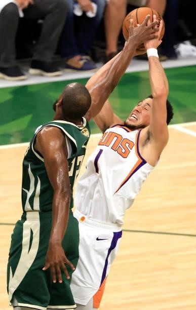 Devin Booker of the Phoenix Suns has his shot blocked by Khris Middleton of the Milwaukee Bucks during the first half in Game Three of the NBA Finals...