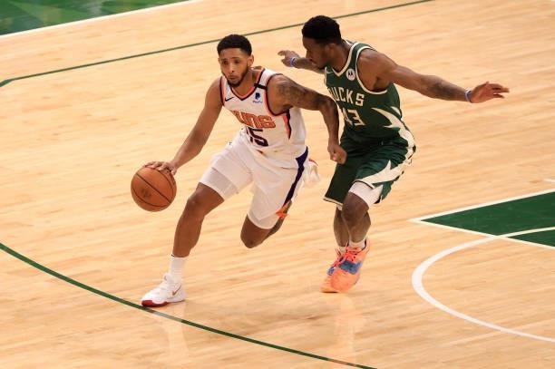 Cameron Payne of the Phoenix Suns brings the ball up the court as he is pressured by Thanasis Antetokounmpo of the Milwaukee Bucks during the first...