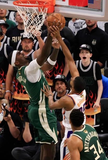 Bobby Portis of the Milwaukee Bucks attempts a layup over Mikal Bridges of the Phoenix Suns during the first half in Game Three of the NBA Finals at...