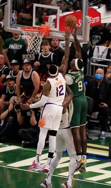 Bobby Portis of the Milwaukee Bucks takes a shot over Torrey Craig of the Phoenix Suns during the first half in Game Three of the NBA Finals at...