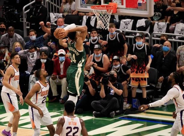 Giannis Antetokounmpo of the Milwaukee Bucks goes up for a dunk during the first half in Game Three of the NBA Finals against the Phoenix Suns at...