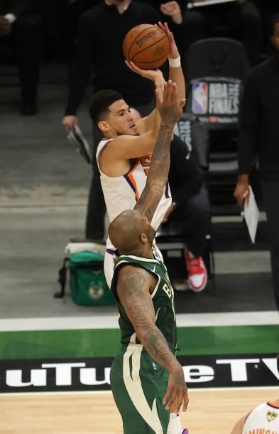 Devin Booker of the Phoenix Suns takes a jump shot during the first half in Game Three of the NBA Finals against the Milwaukee Bucks at Fiserv Forum...