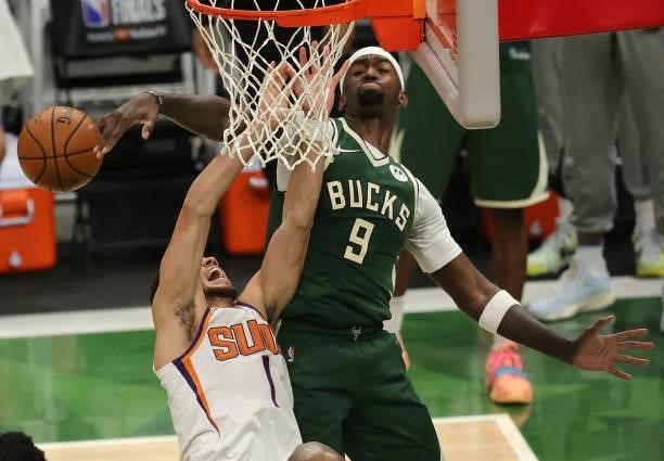Bobby Portis of the Milwaukee Bucks blocks a shot by Devin Booker of the Phoenix Suns during the first half in Game Three of the NBA Finals at Fiserv...