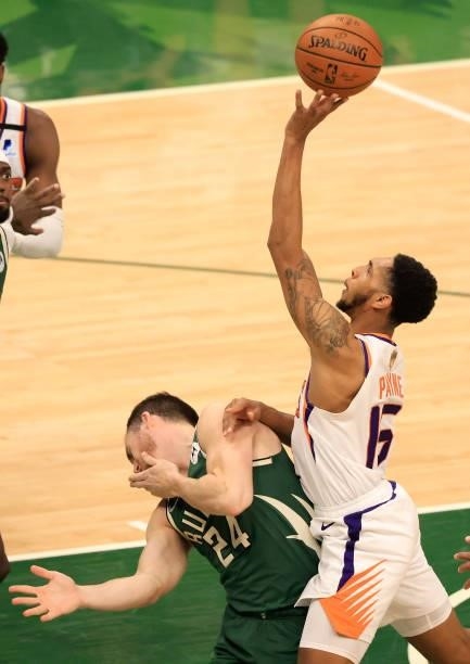 Cameron Payne of the Phoenix Suns shoots over Pat Connaughton of the Milwaukee Bucks during the first half in Game Three of the NBA Finals at Fiserv...