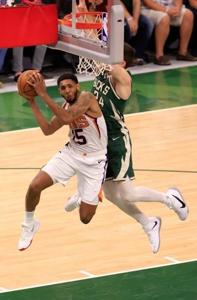Cameron Payne of the Phoenix Suns goes up for a shot against Pat Connaughton of the Milwaukee Bucks during the first half in Game Three of the NBA...