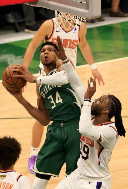 Giannis Antetokounmpo of the Milwaukee Bucks drives into the lane against Jae Crowder of the Phoenix Suns during the second half in Game Three of the...