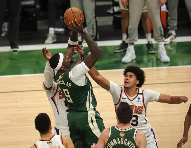 Bobby Portis of the Milwaukee Bucks drives into the lane and shoots over Cameron Johnson of the Phoenix Suns during the second half in Game Three of...