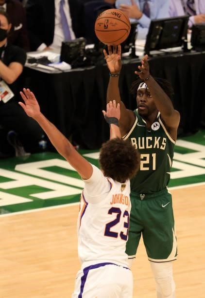 Jrue Holiday of the Milwaukee Bucks takes a shot over Cameron Johnson of the Phoenix Suns during the second half in Game Three of the NBA Finals at...