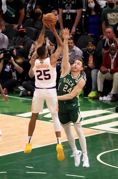 Mikal Bridges of the Phoenix Suns takes a jump shot over Pat Connaughton of the Milwaukee Bucks during the second half in Game Three of the NBA...