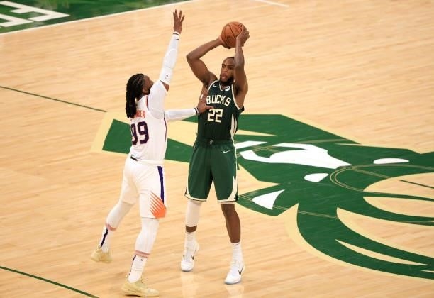 Khris Middleton of the Milwaukee Bucks looks to pass around Jae Crowder of the Phoenix Suns during the second half in Game Three of the NBA Finals at...