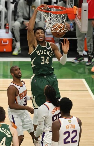 Giannis Antetokounmpo of the Milwaukee Bucks dunks the ball over Jae Crowder and Chris Paul of the Phoenix Suns during the second half in Game Three...