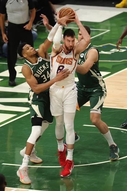 Frank Kaminsky of the Phoenix Suns looks to pass as Giannis Antetokounmpo of the Milwaukee Bucks defends during the second half in Game Three of the...