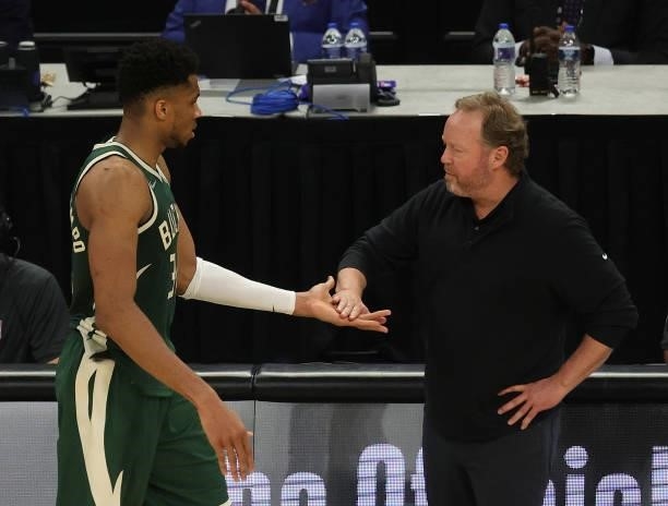 Giannis Antetokounmpo of the Milwaukee Bucks gets a high five from head coach Mike Budenholzer of the Milwaukee Bucks during the second half in Game...