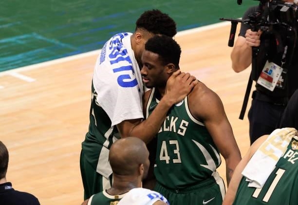 Giannis Antetokounmpo and his brother Thanasis Antetokounmpo of the Milwaukee Bucks celebrate their victory over the Phoenix Suns in Game Three of...
