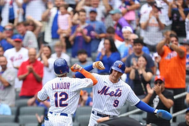Francisco Lindor of the New York Mets high fives Brandon Nimmo after he hit a two-run home run against the Pittsburgh Pirates during the first inning...