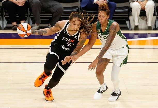 Brittney Griner of the Phoenix Mercury handles the ball against Mercedes Russell of the Seattle Storm during the first half of the WNBA game at...