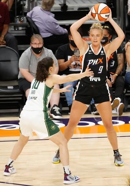 Sophie Cunningham of the Phoenix Mercury looks to pass around Sue Bird of the Seattle Storm during the first half of the WNBA game at Phoenix Suns...