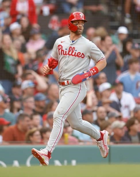 Bryce Harper of the Philadelphia Phillies runs towards home to score against the Boston Red Sox during the eighth inning at Fenway Park on July 10,...
