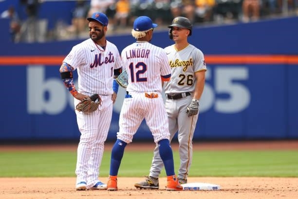 Jonathan Villar and Francisco Lindor of the New York Mets talk with Adam Frazier of the Pittsburgh Pirates during a game at Citi Field on July 11,...