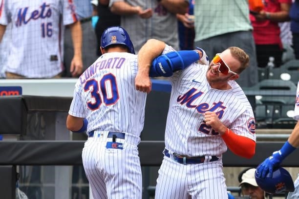 Michael Conforto of the New York Mets is congratulated by Pete Alonso after he hit a three-run home run against the Pittsburgh Pirates during the...