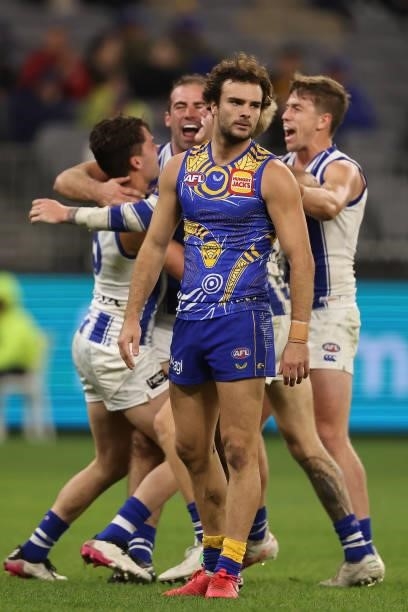 Jack Petruccelle of the Eagles looks as Ben Cunnington of the Kangaroos celebrates a goal during the round 17 AFL match between the West Coast Eagles...