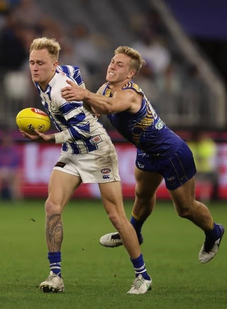 Jaidyn Stephenson of the Kangaroos looks to break from a tackle by Oscar Allen of the Eagles during the round 17 AFL match between the West Coast...