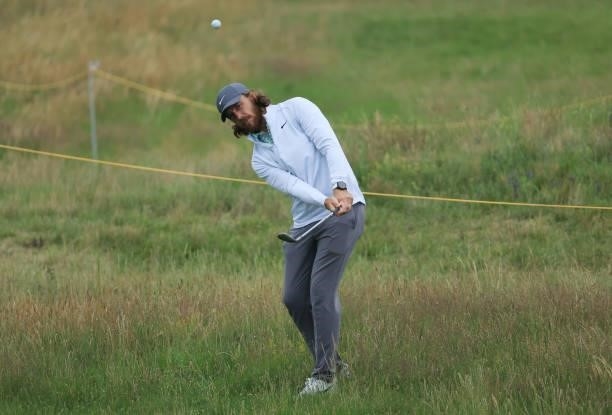 Tommy Fleetwood of England chips out of the rough onto the 7th green during a practice round for The 149th Open at Royal St George’s Golf Club on...