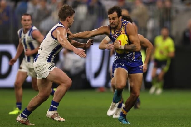 Brendon Ah Chee of the Eagles fends off Trent Dumont of the Kangaroos during the round 17 AFL match between the West Coast Eagles and North Melbourne...