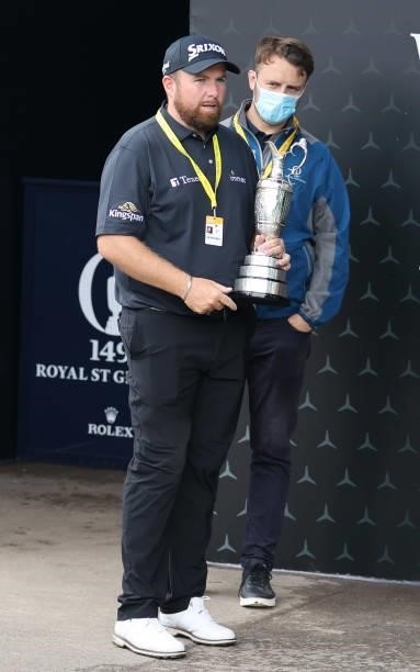In this handout picture provided by the R&A, 2019 winner Shane Lowry of Ireland carries the Claret Jug trophy during a practice round for The 149th...