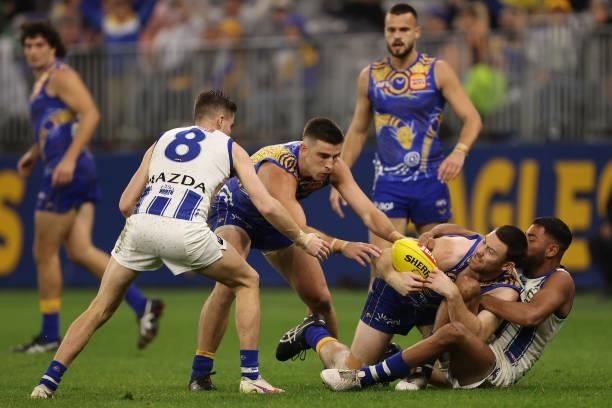 Jeremy McGovern of the Eagles gets tackled by Tarryn Thomas of the Kangaroos during the round 17 AFL match between the West Coast Eagles and North...