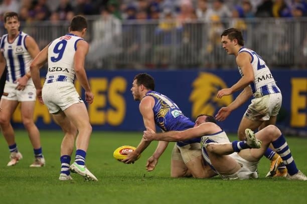 Luke Shuey of the Eagles looks to handball while being tackled by Todd Goldstein of the Kangaroos the round 17 AFL match between the West Coast...