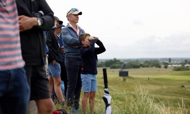 Spectator looks on through binoculars during a practice round for The 149th Open at Royal St George’s Golf Club on July 12, 2021 in Sandwich, England.