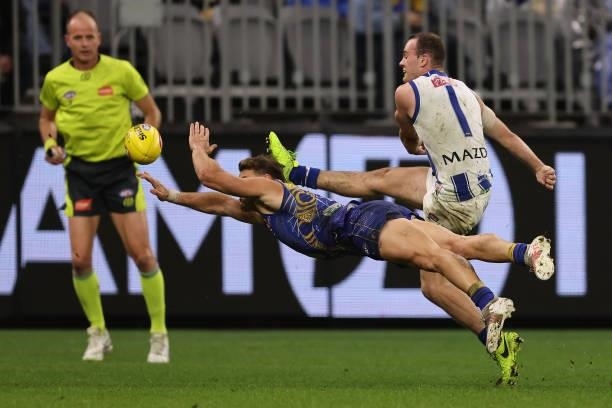 Zac Langdon of the Eagles attempts to smother the kick of Jack Mahony of the Kangaroos the round 17 AFL match between the West Coast Eagles and North...