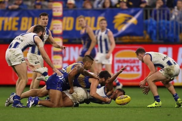 Tarryn Thomas of the Kangaroos gets tackled by Josh J. Kennedy of the Eagles the round 17 AFL match between the West Coast Eagles and North Melbourne...